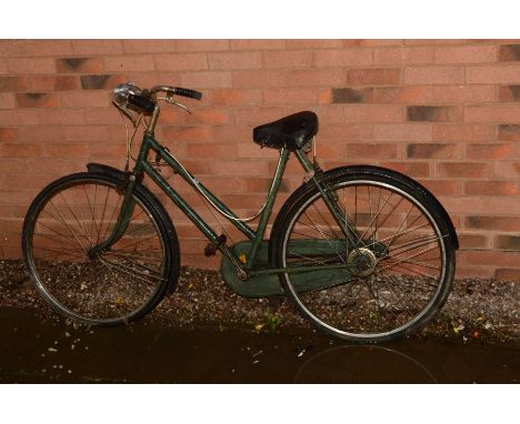 A VINTAGE GREEN LADIES BICYCLE