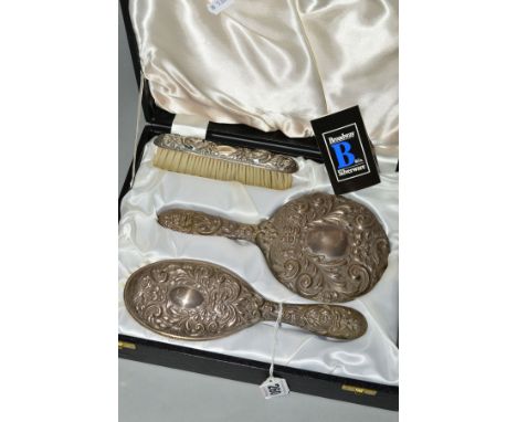 AN ELIZABETH II CASED SILVER BACKED DRESSING TABLE SET, comprising hand mirror, two brushes and a comb, makers Broadway &amp;