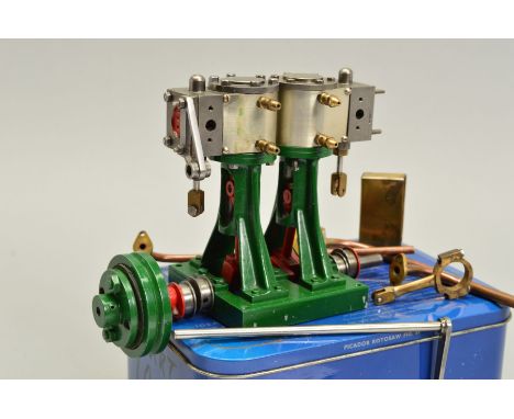 A STUART TURNER D10 VERTICAL TWIN CYLINDER LIVE STEAM ENGINE, not tested, not complete but comes with a tin of parts/spares