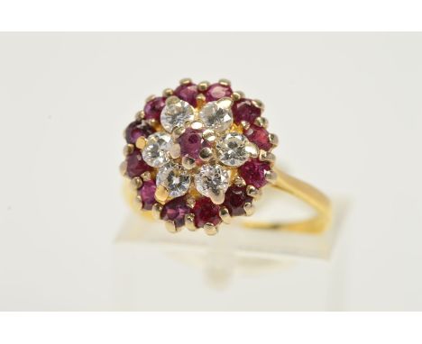 A RUBY AND DIAMOND CLUSTER RING, the central circular ruby within a brilliant cut diamond surround and outer circular ruby bo