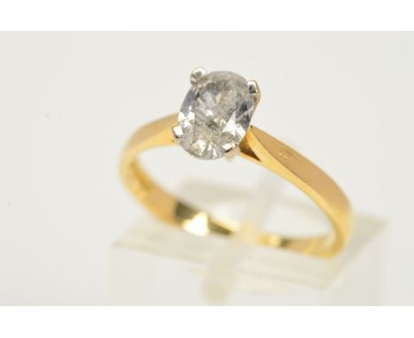 AN 18CT GOLD SINGLE STONE DIAMOND RING, the oval diamond within a four claw setting to the tapered shoulders and plain band, 