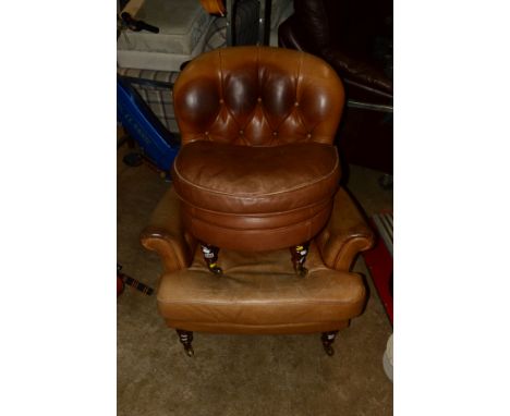 A BEIGE LEATHER SPOON BUTTON BACK ARMCHAIR ON MAHOGANY LEGS together with a matching pouffe (2)