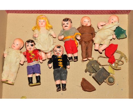 SEVEN MINIATURE BISQUE DOLLS FROM GERMANY, wearing home made clothing, some over painting