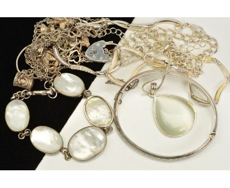 A SELECTION OF SILVER AND WHITE METAL JEWELLERY, to include a hinged silver bangle, a mother of pearl bracelet, a charm brace