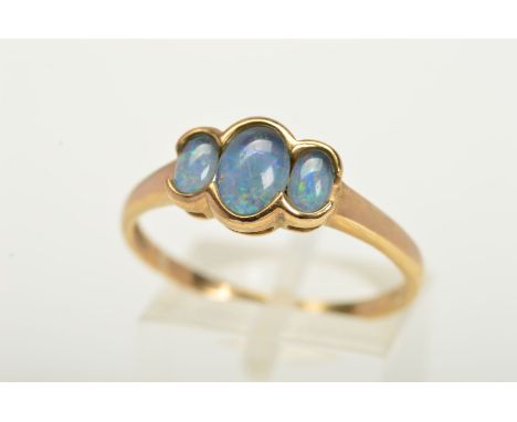 A 9CT GOLD OPAL TRIPLET RING, designed with three graduated opal triplets within part collet mounts to the plain polished ban