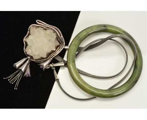 A QUARTZ PENDANT AND A NEPHRITE JADE BANGLE, the pendant of floral design set with quartz crystals and floral design heads se
