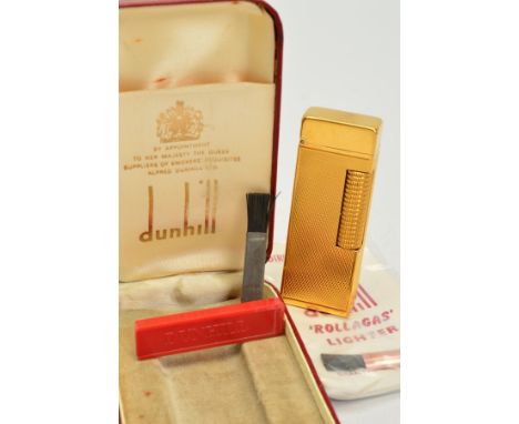 DUNHILL ROLLAGAS LIGHTER, gold plated case with an engine turned design, with replacement flints and it's instructions, fitte