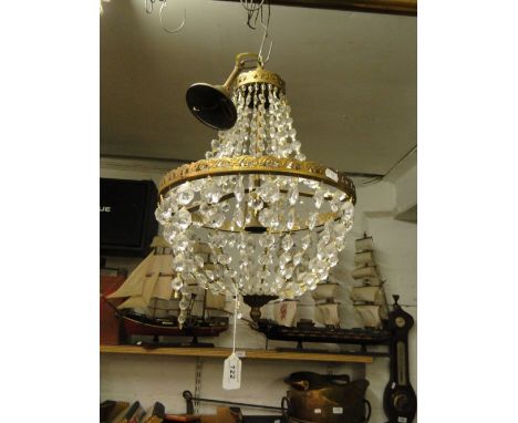 A circular chandelier with lustre drops
