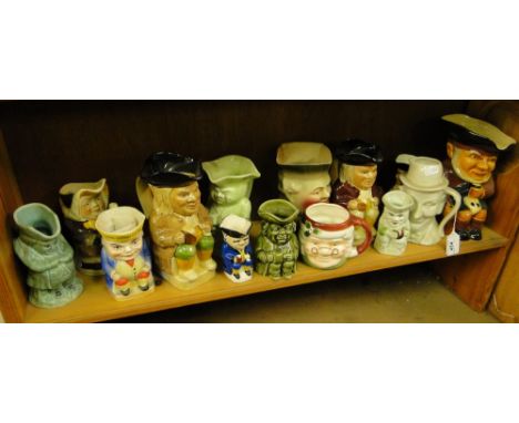 A shelf of various character jugs, including Crown Devon & Tony Wood