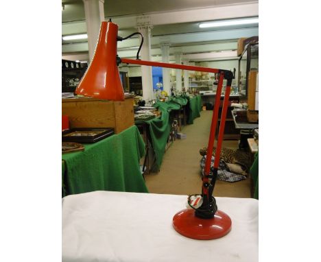 A red Model 90 anglepoise lamp