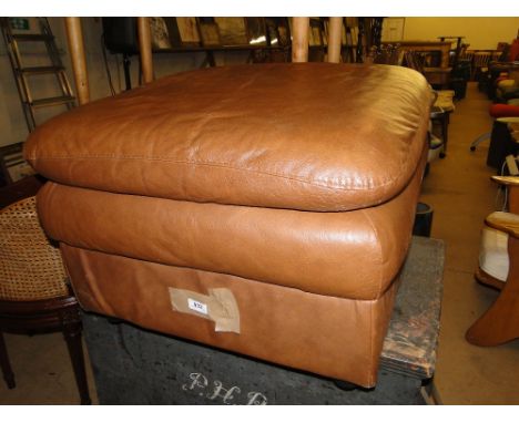 A brown leather pouffe