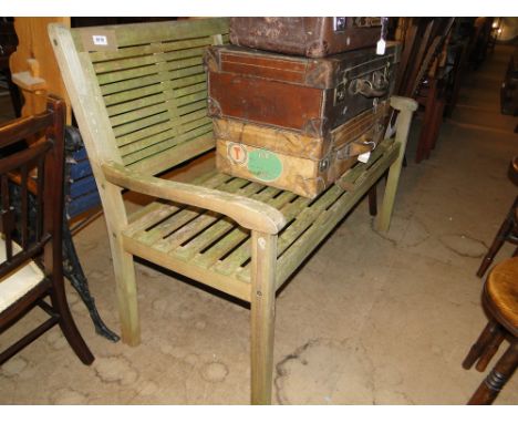 A Modern weathered slatted garden bench