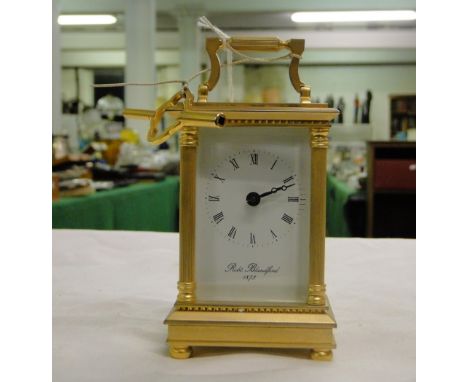 A brass cased carriage clock, with key