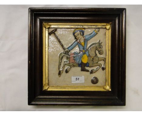 A Persian Islamic ceramic tile with moulded & painted design depicting a polo player, framed