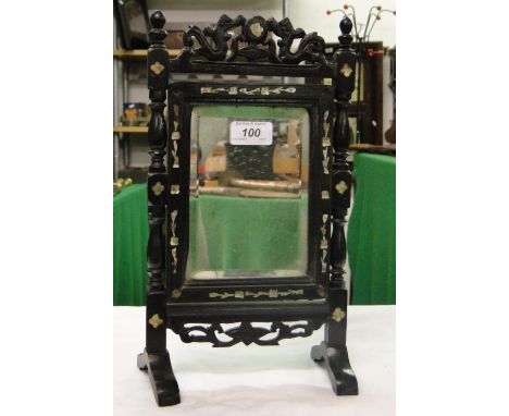 A small swing mirror in carved ebony frame with inlaid mother of pearl