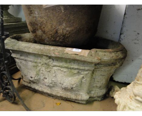 A Weathered embossed concrete garden planter