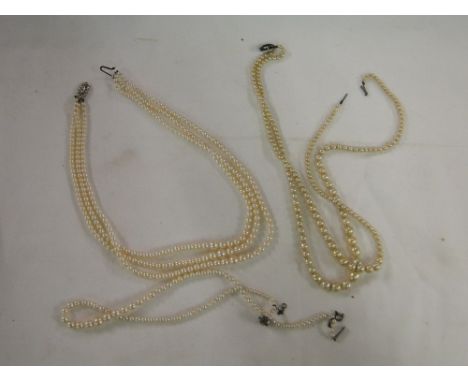 A 3 strand pearl necklace, with a 9 ct white gold & diamond set clasp;  & a 2 strand pearl necklace with a silver clasp, & a 