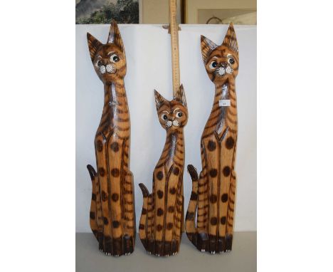 Three wooden model cats
