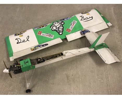 A large petrol engine radio controlled plane - Green & white coloured.  Length 113cm, wingspan 130cm