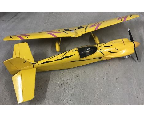 A large petrol engine radio controlled plane - Yellow coloured.  Length 129cm, wingspan 150cm