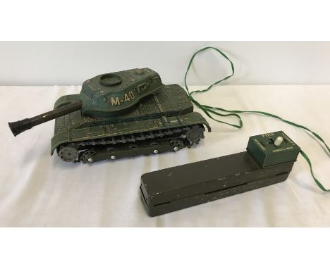 A vintage "Modern Toys", Made in Japan, battery operated M-40 tinplate tank. With wired remote control. 