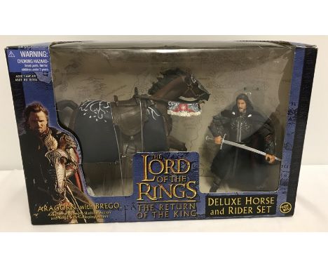 A boxed set of The Lord Of The Rings, The Return Of The King figure set. Aragorn with Brego with swords slashing and gallopin