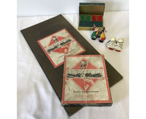 A quantity of vintage toys comprising Monopoly board game, Guinness playing cards and wind up toys.  