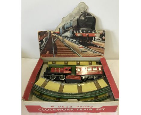 A vintage Chad Valley tinplate clockwork trainset. In original box. With key. 
