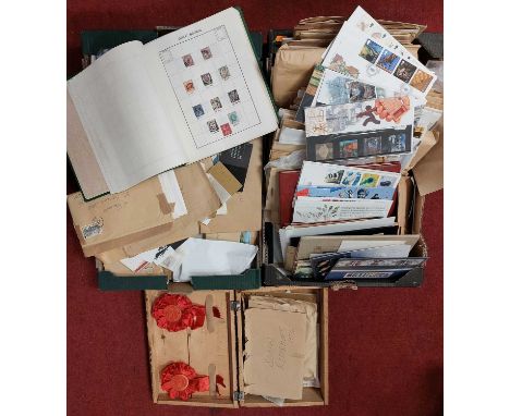 A large collection of first day covers presentation packs, postcards and stamps (two boxes)