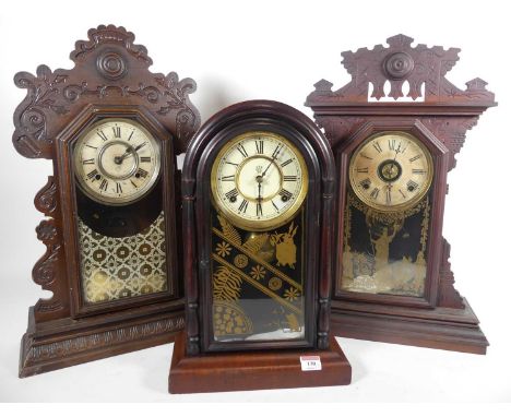 An early 20th century dome top mantel clock, h. 44cm, together with two gingerbread type mantel clocks (3)