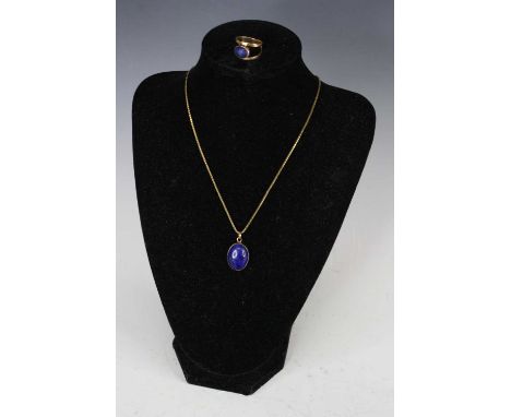 A 9ct gold lapis lazuli set dress ring, size K; together with a lapis lazuli and 9ct gold mounted pendant, on gilt metal neck