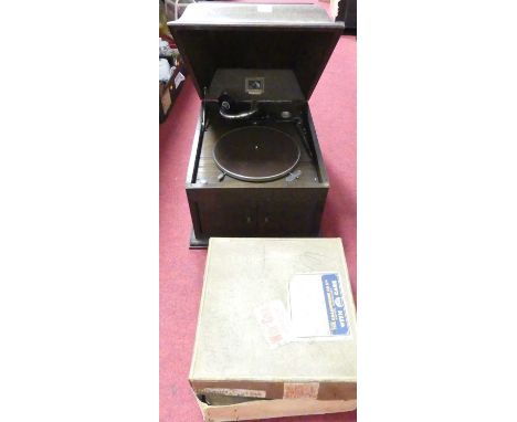 An oak cased gramophone together with a box of records