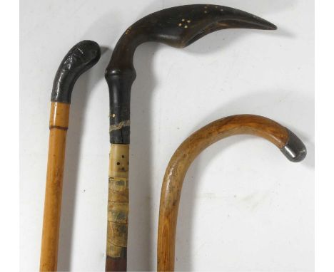 A silver tipped walking stick, together with two other examples 