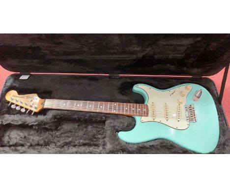 A turquoise Stratocaster electric guitar in hard casePlease note amended description; this is not by Fender, no marks on tune