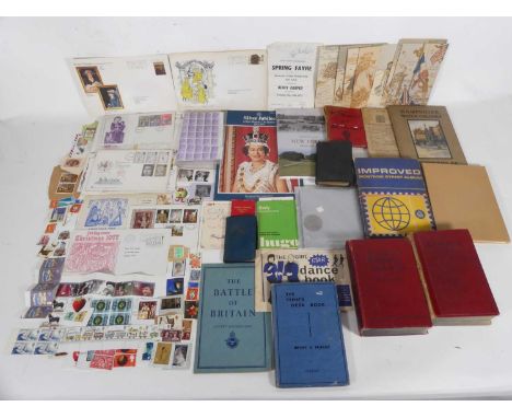 A box of first day covers, books, stamps, and French postcards from WWI to include Christmas examples