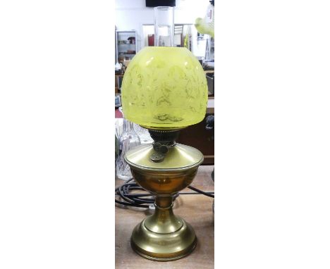 An early 20th century brass oil lamp, having an etched yellow glass shade, h.46cmShade with some very small chips to rim.Lamp