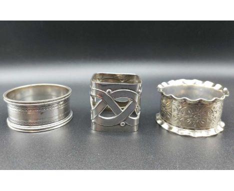 A WMF celtic design napkin ring and two others (3).