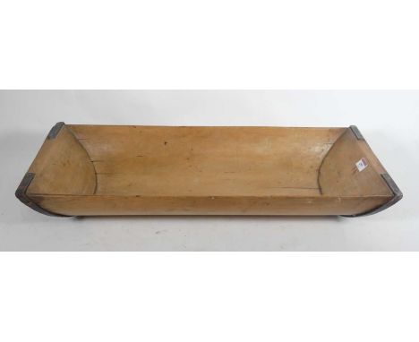 A small wooden dough trough