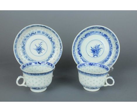 Two sets of Chinese rice grain pattern teacups and saucers, Qing Dynasty late 19th century, each pierced in the body with ric