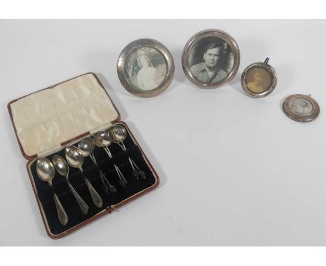 A collection of silver to include coffee spoon and silver clad easel photograph frame