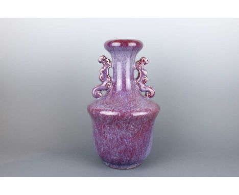 A Chinese flambé-glazed vase with two handles, first half of the 20th century, heavily potted with a tampering body supportin