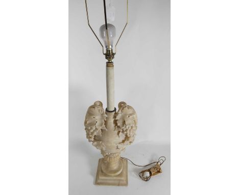 A carved alabaster lamp base decorated with fruiting vines, height 84cm