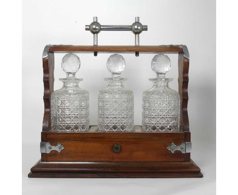 An Edwardian mahogany and chrome metal mounted three decanter tantalus (locked, without key), height 34cmOne decanter with la