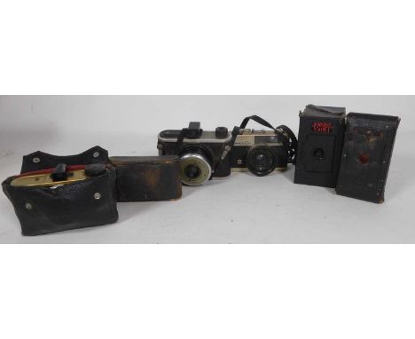 A box of cameras to include Konica C35, Kodak, and boxed camera examples