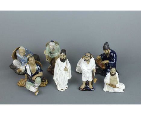 A group of Chinese Shiwan figures, 20th century, including a scholar playing zither and his servant, two old fishermen, one w