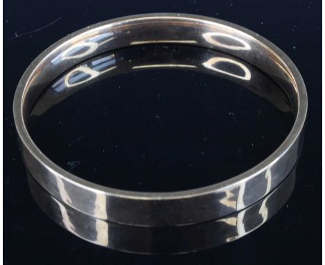 A 9ct gold hollow bangle, sponsor RP Ltd, dia.7.5cm, 12.1gA few light dents. Light surface scratches throughout.