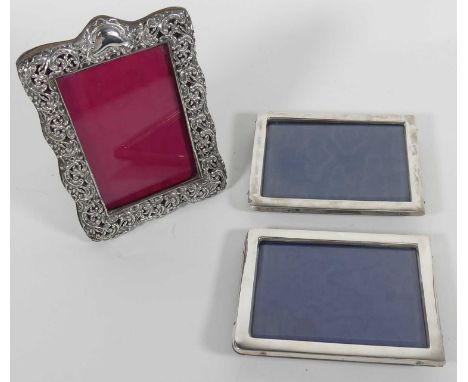 A Victorian repoussee silver clad easel photograph frame, 14x9.5cm, together with two further repoussee decorated silver fram