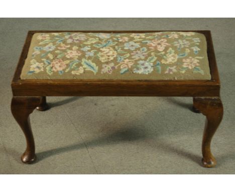 A Georgian style oak stool, early 20th century, the drop-in seat upholstered in foliate tapestry, on cabriole legs. 