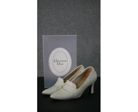 A pair of boxed Christian Dior cream Nappa leather heeled loafers, size 4 1/2. 
