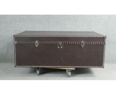 A Dentro Vittoria Steamer Trunk, upholstered in studded chocolate brown leather and having two side drawers. H.43 W.102 D.70c